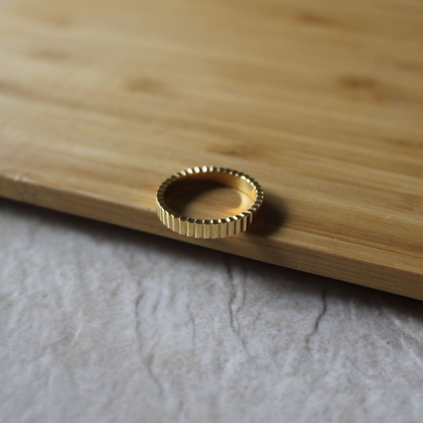 Minimal gold ribbed ring 